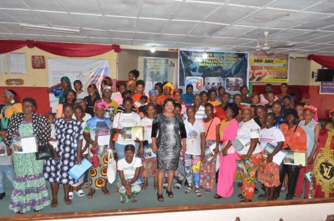 Women proudly holding their Wealth Trust training certificates